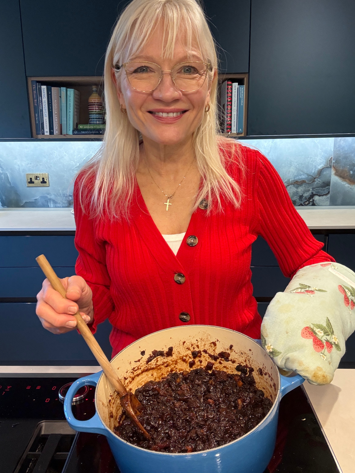 April Harris in her kitchen with a Le Creuset casserole on the stove top. The casserole contains suet-free mincemeat, cooked and ready to be put into jars.