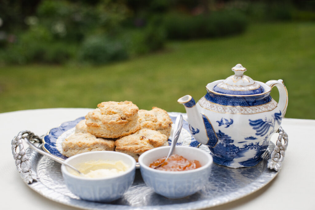 Apricot and Ginger Scones served on a silver tray with clotted cream, jam and a pot of tea
